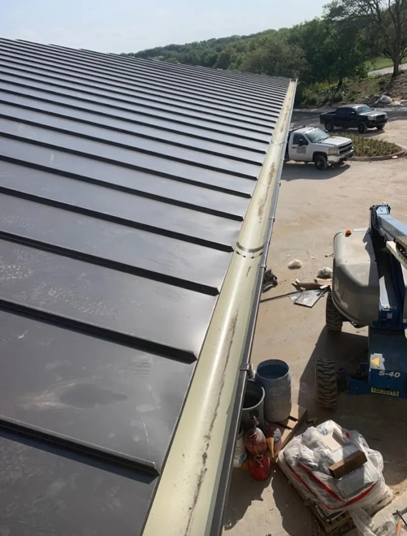 Standing seam panel and gutter detail on a metal roofing jobsite in Morrisville